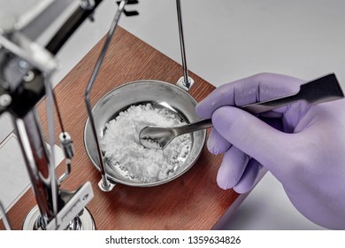 Pharmacist or scientist preparing medicine using precision weighing - Powered by Shutterstock