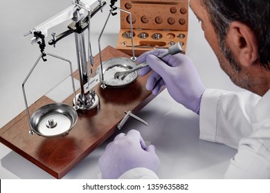 Pharmacist or scientist preparing medicine using precision weighing - Powered by Shutterstock