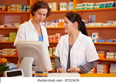 Pharmacist Training A Pharmacy Technician In A Drugstore