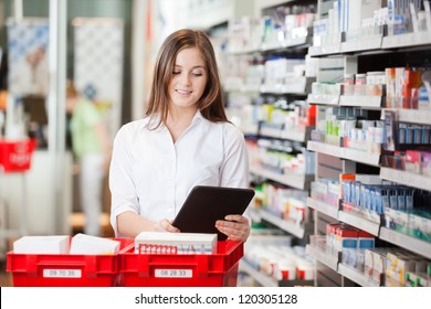 Pharmacist Using A Digital Tablet While Filling Prescriptions