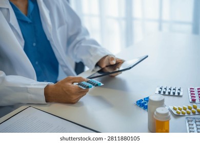 Pharmacist using tablet for dispensing medication.