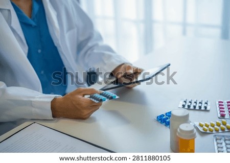 Pharmacist using tablet for dispensing medication.