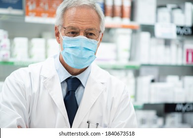 Pharmacist Wearing A Coronavirus Or Covid Mask In His Pharmacy Shop