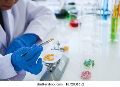 Pharmacists measure dosing using weighted scales - Powered by Shutterstock