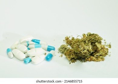 pharmacological pills, and pile of marijuana, white background