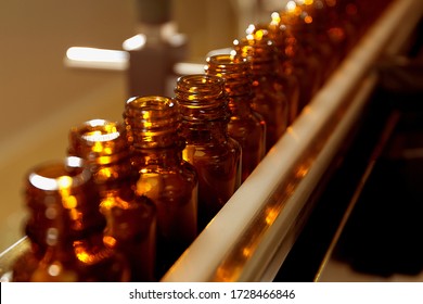 Pharmacological production. Sterile bottles and ampoules on the dispensing line. Sealed ampoules with medicine. Sterile capsules for injection Bottles on the bottling line of the pharmaceutical plant