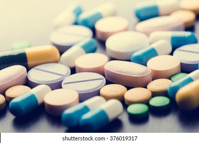 Pharmacy background on a black table. Tablets on a black background. Pills. Medicine and healthy. Close up of capsules. Different kind of medicines