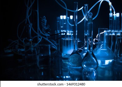 Pharmacy and chemistry theme. Test glass flask with solution in research laboratory. Science and medical background. Laboratory test tubes on dark toned background , science research equipment concept