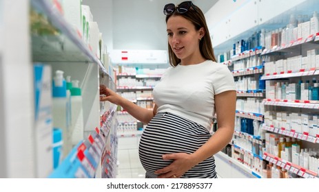 Pharmacy Customer Pregnant Woman. Happy Pregnancy Female Customer In Retail Health Drugstore. Concept Of Pregnancy, Maternity, Expectation For Baby Birth