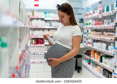 Pharmacy Customer Pregnant Woman. Happy Pregnancy Female Customer In Retail Health Drugstore. Concept Of Pregnancy, Maternity, Expectation For Baby Birth