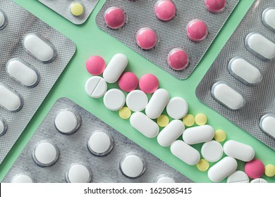 Pharmacy drugs, tablets in blister on a green background, painkillers and other medical products - Shutterstock ID 1625085415