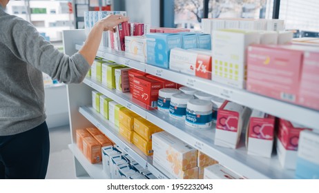 Pharmacy Drugstore: Anonymous Woman Chooses And Picks The Best Medicine Package, Supplemen Box, Drugs, Pills Of The Shelf, She Wants To Buy It. Modern Pharma Store Health Care Products