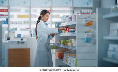 Pharmacy Drugstore: Beautiful Asian Pharmacist Does Inventory, Arranges Medicine Packages, Drugs, Vitamins, Health Care Products on a Shelf. Professional Pharmacist in Pharma Store - Powered by Shutterstock