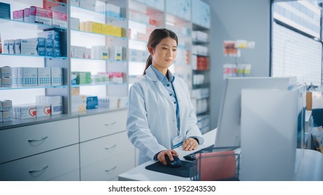 Pharmacy Drugstore: Beautiful Asian Pharmacist Uses Checkout Counter Computer, Does Inventory Checkup, Online Prescription Of Medicine Packages, Drugs, Vitamin Boxes, Supplements, Health Care Products