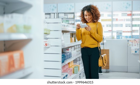 Pharmacy Drugstore: Beautiful Black Young Woman Walking Between Aisles And Shelves Shopping For Medicine, Drugs, Vitamins, Supplements, Health Care Beauty Products With Modern Package Design