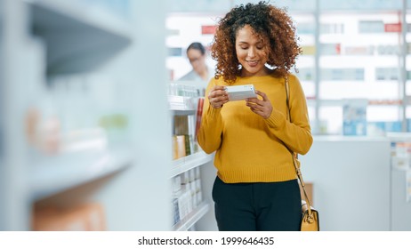 Pharmacy Drugstore: Beautiful Black Young Woman Walking Between Aisles And Shelves Shopping For Medicine, Drugs, Vitamins, Supplements, Health Care Beauty Products With Modern Package Design