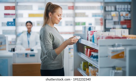 Pharmacy Drugstore: Beautiful Caucasian Young Woman Chooses To Buy Medicine, Drugs, Vitamins, Searches Shelves For The Best Choice. Modern Pharma Store Shelves With Health Care, Beauty Products