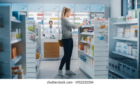 Pharmacy Drugstore: Beautiful Young Woman Chooses To Buy Medicine, Drugs, Vitamins, Searches For The Best Choice. Modern Pharma Store Shelves With Health Care, Beauty Products