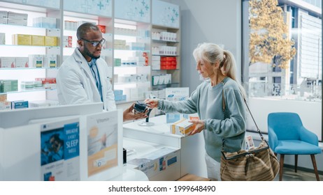 Pharmacy Drugstore Checkout Counter: Professional Black Pharmacist Provides Best Customer Service To Diverse Group Of Multi-Ethnic Clients Buying Medicine Paying With Contactless Payment Credit Cards