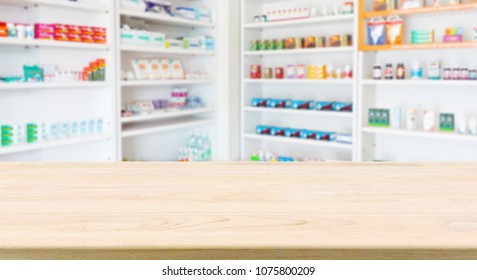 Pharmacy Drugstore Counter Table With Blur Abstract Background With Medicine And Healthcare Product On Shelves