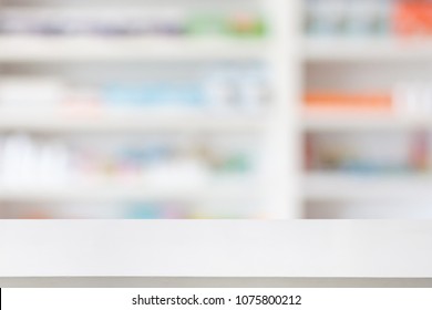 Pharmacy Drugstore Counter Table With Blur Abstract Background With Medicine And Healthcare Product On Shelves