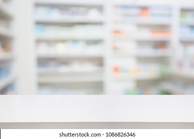 Pharmacy Drugstore Counter Table With Blur Abstract Background With Medicine And Healthcare Product On Shelves