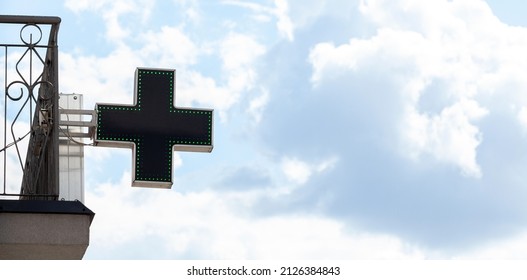 Pharmacy Drugstore Cross Shaped Led Signage, Cloudy Sky Wide Background, Copy Space, Nobody. Health Care Medical Supplies, Pharmaceutical Industry Concept, Healthcare Cross Symbol Sign, No People