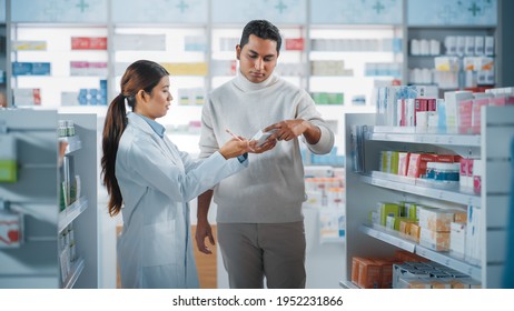 Pharmacy Drugstore: Female Asian Pharmacist Helping Indian Male Customer With Recommendation, And Advice To Buy Medicine, Drugs, Vitamins. Modern Pharma Store Shelves With Health Care Products