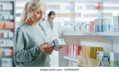 Pharmacy Drugstore: Portrait Of A Beautiful Senior Woman Choosing To Buy Medicine, Drugs, Vitamins. Apothecary Full Of Health Care Products, Supplement Bottles, Beauty Packages With Modern Design