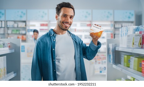 Pharmacy Drugstore: Portrait of Handsome Latin Man Choosing to Buy Vitamins, Showing the Correct Box, Smiles Happily on Camera. Store with Health Care Products. Customer Recommending Best Vitamins.