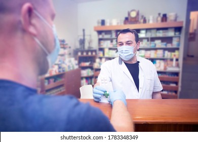 Pharmacy During Covid-19. Shopper In Drugstore. People In Protective Medical Masks Buys Medicine. Pharmacy, Pharmacist. Covid And Retail