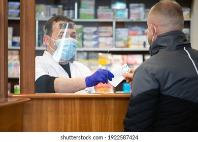 Pharmacy During Covid-19. Shopper In Drugstore. People In Protective Medical Masks Buys Medicine. Pharmacy, Pharmacist. Covid And Retail