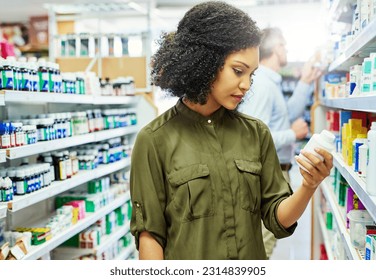 Pharmacy, health shop and woman with medicine for reading label, check product and choice in retail store. African female person looking at drugstore pills for ingredients, information and shopping - Powered by Shutterstock