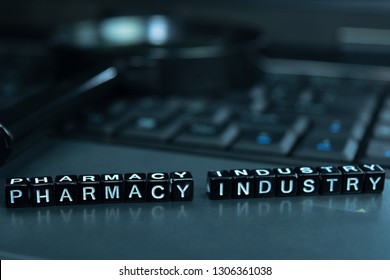 Pharmacy Industry text wooden blocks in laptop background. Business and technology concept - Shutterstock ID 1306361038