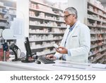 Pharmacy, medicine and doctor on computer search for pills information or system inventory in stock management. Mature man or retail pharmacist with online database for medical tablet and medication
