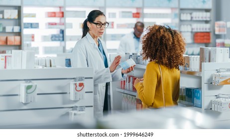 Pharmacy: Professional Caucasian Pharmacist Helping Beautiful Black Female Customer With Medicine Recommendation, Advice, Talking. Drugstore With Full Of Drugs, Pills, Health Care, Beauty Products