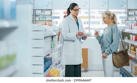 Pharmacy: Professional Pharmacist Helping Beautiful Senior Female Customer With Medicine Recommendation, Advice, Talking. Drugstore With Full Of Drugs, Pills, Health Care, Beauty Product Packages