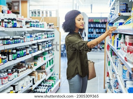 Pharmacy, shopping and woman search for medicine and product in a retail store. Pharmaceutical, drugs and pills with a African female person looking at box for ingredients and information in shop