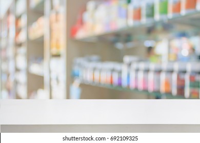 Pharmacy Store Counter Table Top With Blur Medicine On Shelves In The Drugstore Background