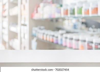 pharmacy store counter table top with blur medicine on shelves in the drugstore background