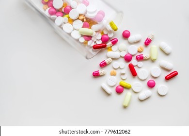 Pharmacy theme cure in container for health. Heap of red,yellow, white round and ova lcapsule, pills with medicine antibiotic. Drug prescription for treatment medication.  Antibiotic painkiller 