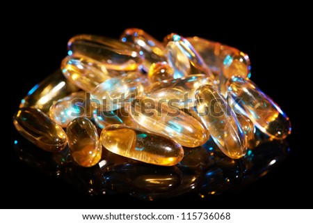 Pharmacy theme, Heap of yellow round medicine antibiotic pills with omega-3 fish fat oil. Shallow DOF