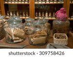 Pharmacy Traditional Chinese Medicine. Glass bottles with natural medicines on the table Chinese pharmacies. Natural medicine made from dried herbs in pharmacy shop. Therapeutic drugs from herbs.