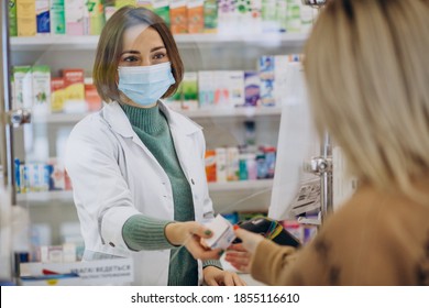 Pharmasict serving customer at drug store