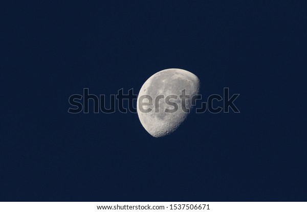 A phase
of the moon against a blue sky in the
UK.