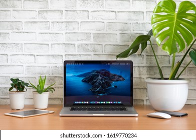 PHATTHALUNG, THAILAND - January 12, 2020: Apple Macbook Pro Computer With Ipad, Iphone, Mouse And Monstera Tree Pots On Wooden Table, Created By Apple Inc.