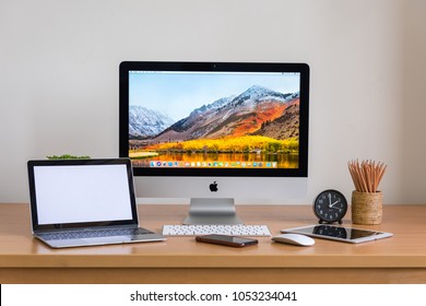 PHATTHALUNG, THAILAND - MARCH 24, 2018: IMac Monitor Computers, IPhone, Ipad, Keyboard And Magic Mouse On White Desk, Created By Apple Inc.