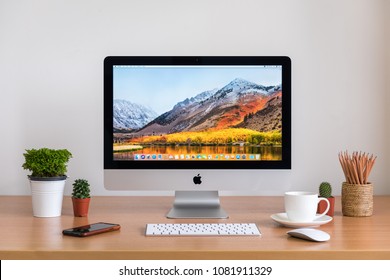 PHATTHALUNG, THAILAND - MARCH 24, 2018: IMac Monitor Computers, IPhone, Keyboard, Magic Mouse  And Coffee Cup On White Desk, Created By Apple Inc.