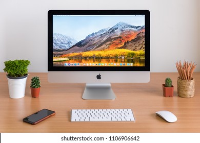 PHATTHALUNG, THAILAND - MARCH 24, 2018: IMac Monitor Computers, IPhone, Keyboard, Magic Mouse  And Plants Vase On White Desk, Created By Apple Inc.