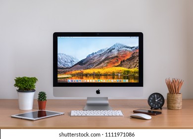 PHATTHALUNG, THAILAND - MARCH 24, 2018: IMac Computers, IPhone, IPad, Plant Vase, Cactus, Pencils  And Clock On Wooden Table, Created By Apple Inc.